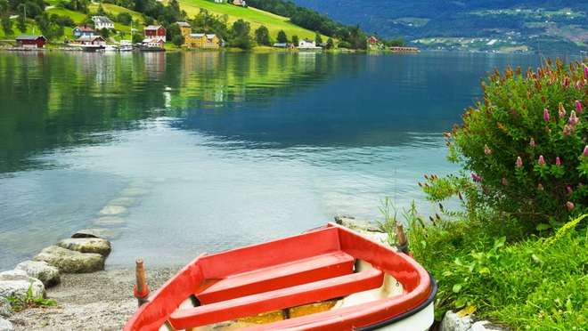 Breathe crisp fjord air beneath soaring peaks