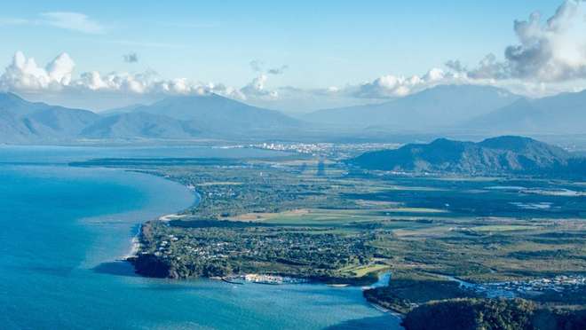 Enjoy warm ocean breezes on Cairns' sandy beaches